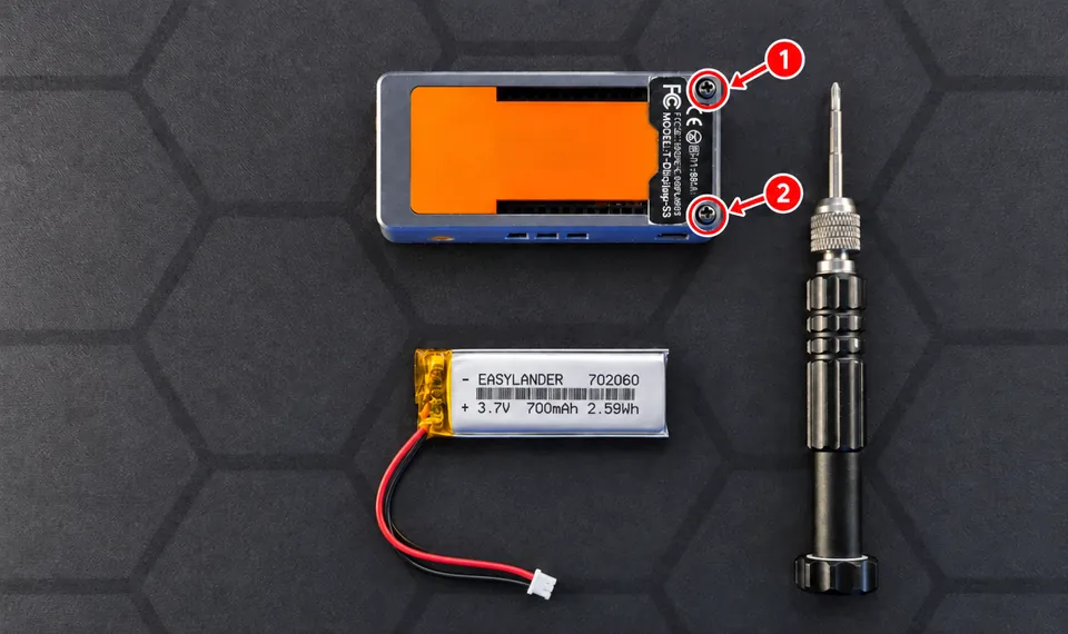 T-Display-S3 case with its two screws marked, next to the battery and a screwdriver