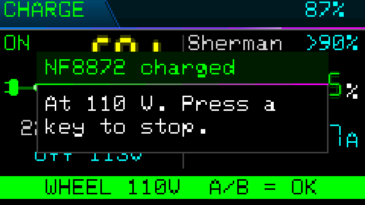 Charge page alert: a popup reads NF8872 charged, At 110 V. Press a key to stop, over a WHEEL 110V A/B = OK banner